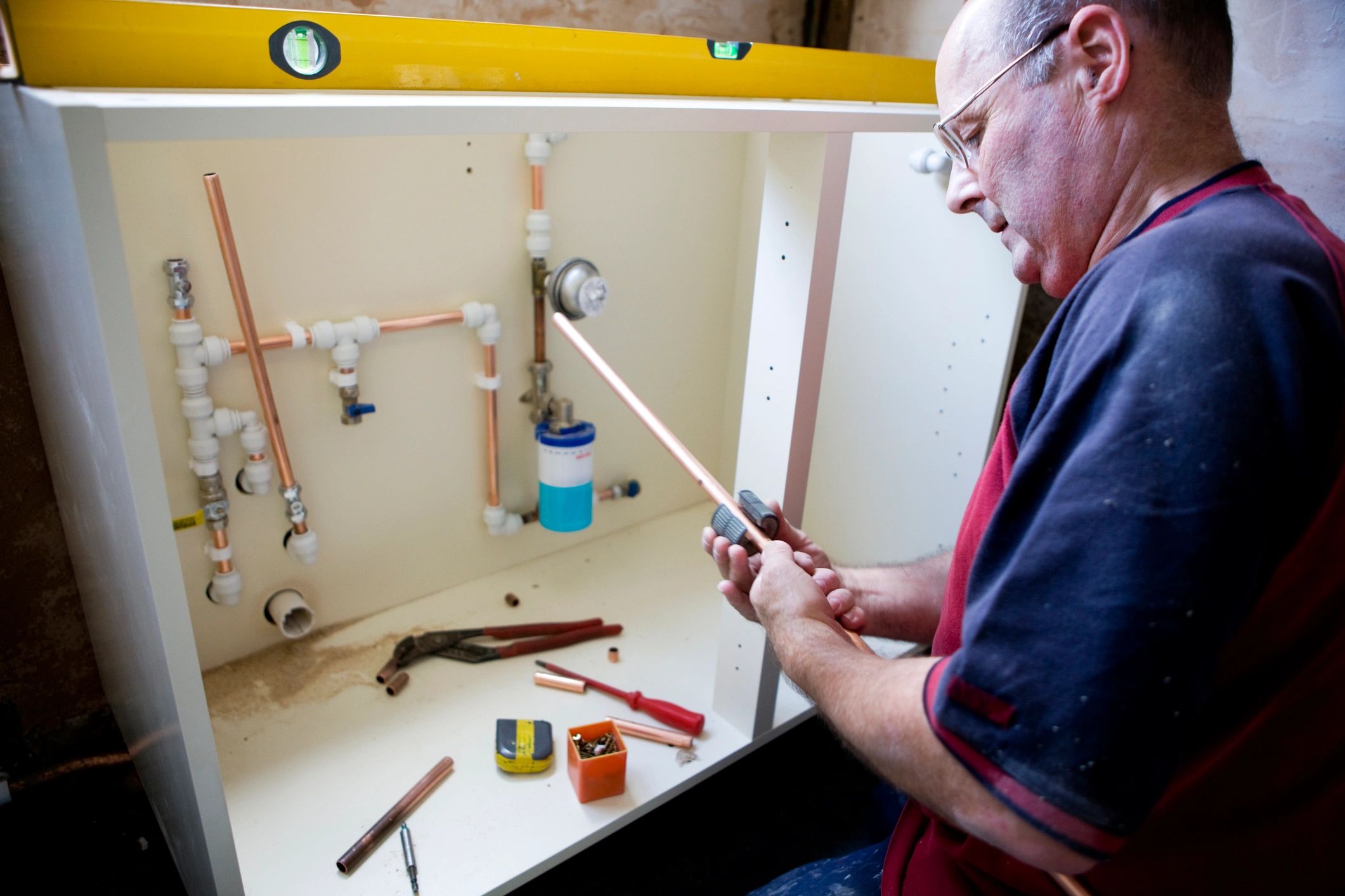 Plumber working on domestic pipework